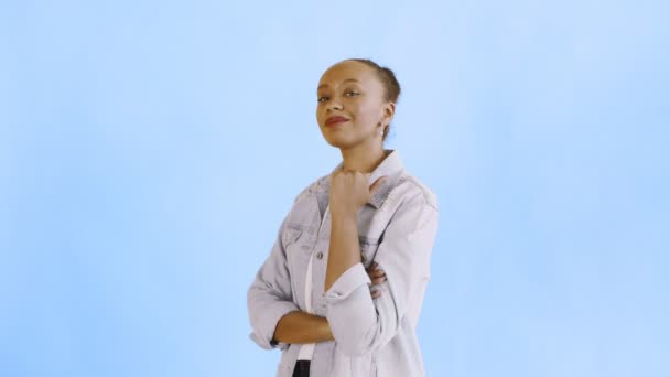 Young happy African woman giving thumbs up on blue background Jean jacket — Stock Video