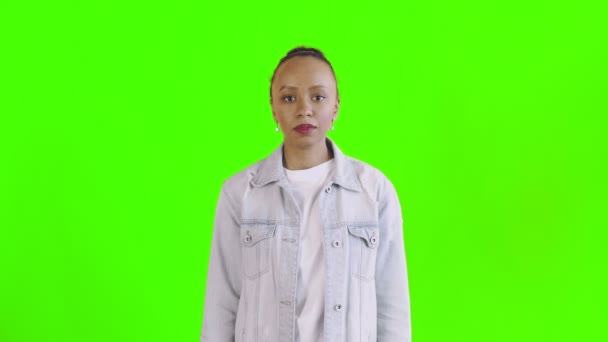 Shoot afro-amerikai nő nézi kamera zöld háttér Jean kabát — Stock videók