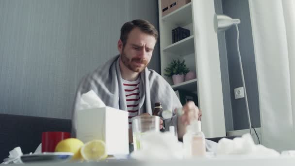 Nemocný muž nalévá léky nebo antipyretický sirup lžící a pije — Stock video