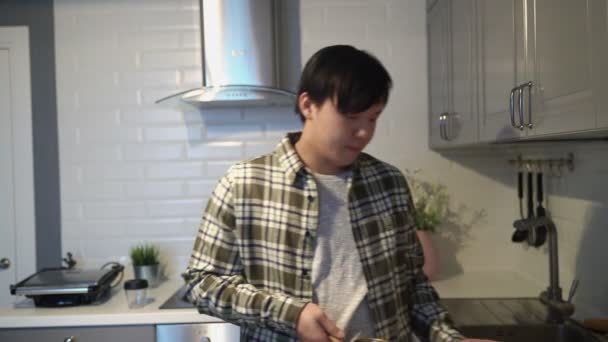 Mladý nemocný asijské pití turecké kávy v kuchyni doma — Stock video