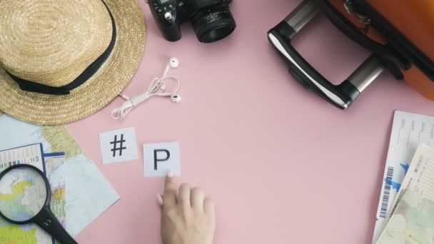 Top view hands laying on pink desk word PARIS — Stock Video