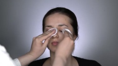 Makyajdan önce cilt kremi süren genç, güzel ve doğal bir kadının stüdyo portresi.