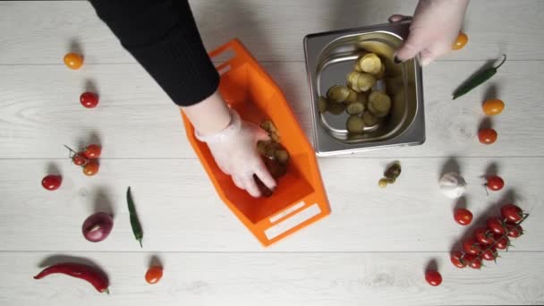 Chefe leva fatia de pepinos em picles de tigela de plástico e coloca-los em recipiente de metal — Vídeo de Stock