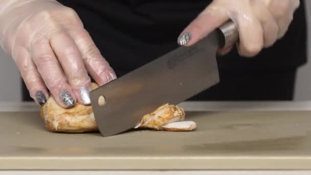 Шеф-повар режет жареного цыпленка на пластиковой доске — стоковое видео