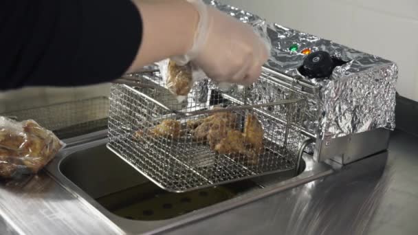 Process of cooking chicken Buffalo wings in the deep fryer — Stock Video