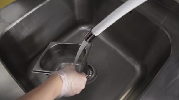 Vrouw wast metalen container in de keuken in het restaurant — Stockvideo
