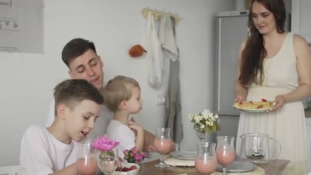 Gros plan de la famille heureuse assis autour de la table de cuisine le matin manger des gaufres sur le petit déjeuner ensemble — Video