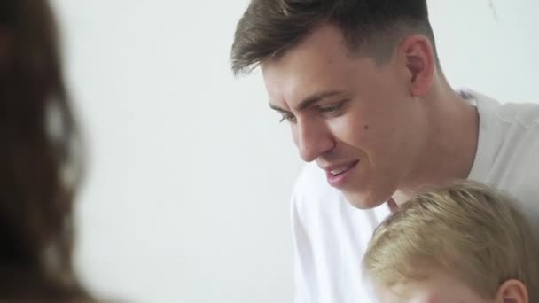 Close up of handsome father and two his sons having breakfast at the morning — Stock Video