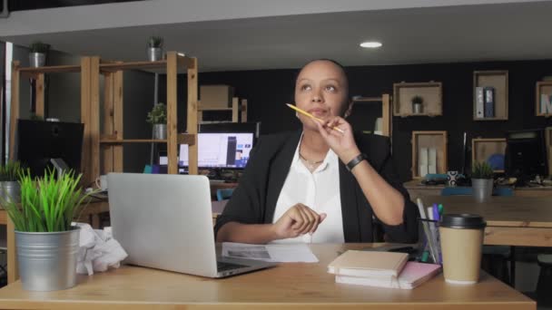 Στοχαστική Αφροαμερικανή γυναίκα σκέφτεται και γυρίζοντας μολύβι στο χέρι στο γραφείο συνεργασίας — Αρχείο Βίντεο
