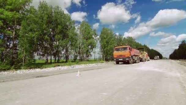 Kırsal alanda kamyonlar, kazıcılar ve yol onarımı çalışmaları. — Stok video