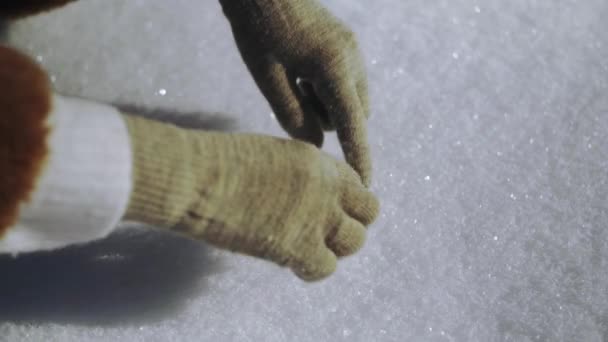 Close-up van vrouw met winter handschoenen verf het hart op de sneeuw — Stockvideo