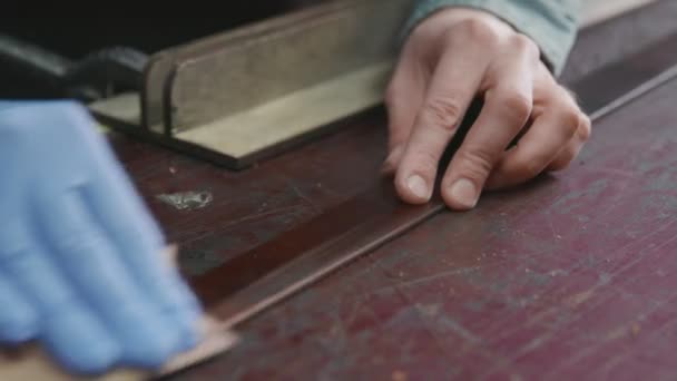 O bronzeador profissional está a afiar um cinto. O mestre de couro está fazendo um cinto — Vídeo de Stock