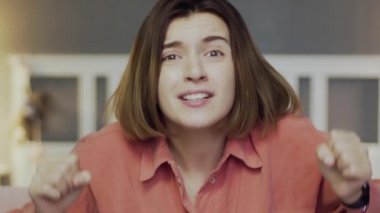 Hayal kırıklığına uğramış kadın futbol fanatiği kanepede oturmuş futbol maçı izliyor.