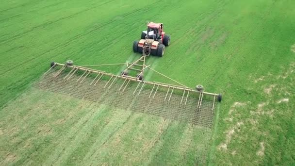 Luchtfoto van een boer in trekker die land bereidt op landbouwgrond. Top down view witte trekker ploegen velden, het voorbereiden van land voor het zaaien. — Stockvideo