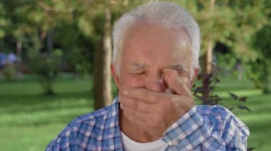 Duyguları olan yaşlı bir adam portresi. Büyükbaba gülümsüyor ve kameraya bakıyor..