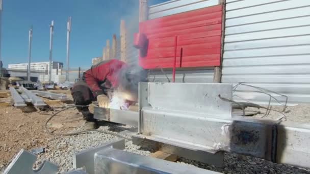 Man welder welds the parts of structure on Construction Site — Stock Video