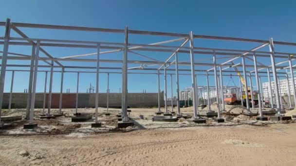 Building workers are constructing a metal framework. New constructions site development — Stock Video