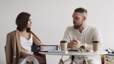 Arkadaşlar kahve içiyor ve kafede toplantı sırasında yeni iş planlarını tartışıyorlar..