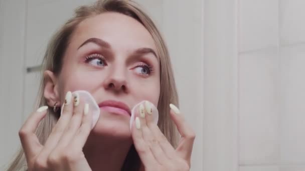 Kvinna tillämpa lotion och titta i spegeln njuta av naturlig skönhet och hälsosam — Stockvideo