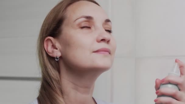 Nahaufnahme Erwachsene Frau Anwendung von Wasserspray für die Hydratation der Haut — Stockvideo