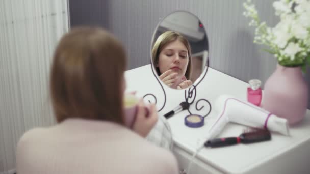 Ung, söt kvinna dricker kaffe framför spegeln — Stockvideo