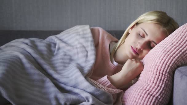 Young beautiful woman wakes up on couch in living room — Stock Video