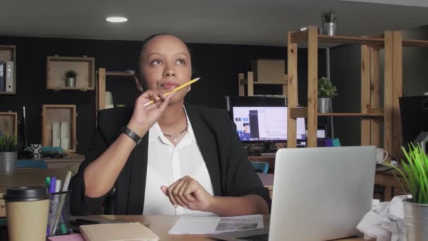 Gondolkodó afro-amerikai nő gondolkodik és ceruzával a kezében forog a coworking irodában — Stock videók