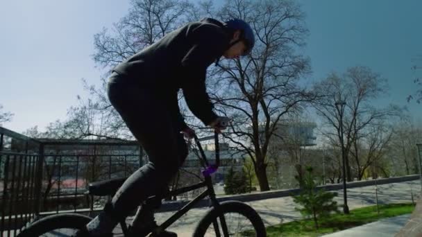 Un joven jinete de bmx practicando en el parque de skate vacío — Vídeos de Stock