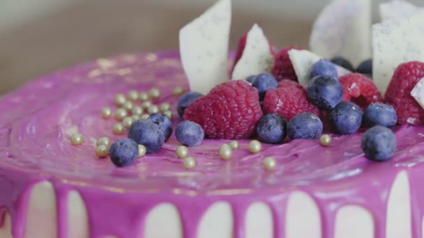 Decora el pastel con bayas, chocolate blanco y bolas de azúcar — Vídeo de stock