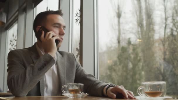Kafede cep telefonu olan bir adam — Stok video