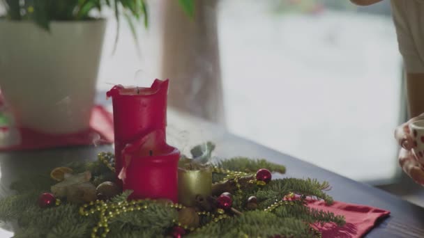 Jonge vrouw blaast kerstkaarsen uit. Klassiek Nieuwjaar of kerst versiert — Stockvideo