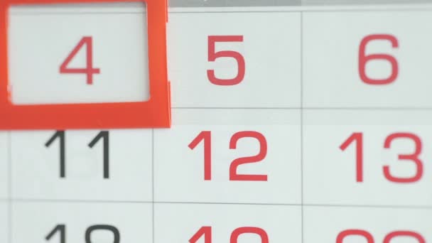 Womans hand in office changes date at wall calendar. Changes 4 to 5 — Stock Video