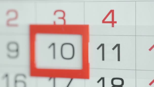 Womans hand in office changes date at wall calendar. Changes 10 to 11 — Stock Video