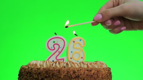 Lighting a number twenty six birthday candle on a delicious cake, green screen 26 — Stock Video