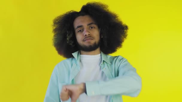 Afro-amerikai férfi Gesturing hüvelykujj le a sárga háttér — Stock videók