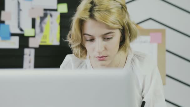 Primer plano de la mujer europea tomando notas en bloc de notas usando pluma en la oficina moderna — Vídeos de Stock