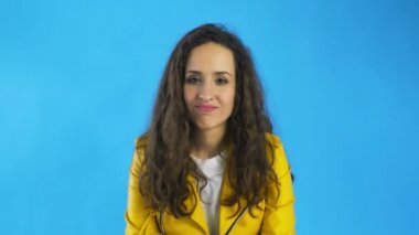 Kafası karışmış bir kadın sarı arka plan için kafa sallamak yok diyor.