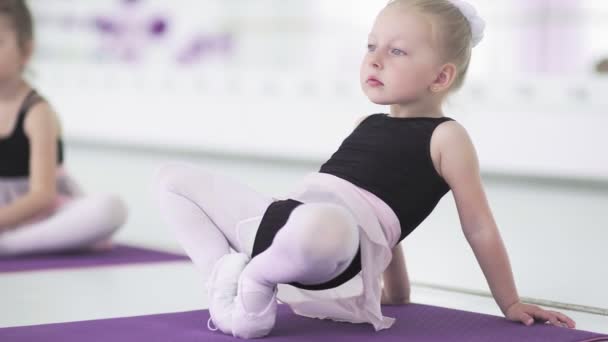 Niñas estirándose y haciendo ejercicios en la escuela de ballet — Vídeo de stock
