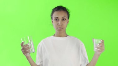 Krom anahtar arka planında plastik ve cam bardakları olan Afro-Amerikalı Kız Eylemci