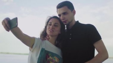 Genç bir aile dinleniyor ve selfie çekiyor.