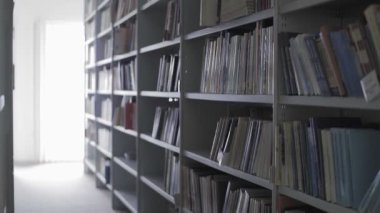 Kütüphane raflarının bir sürü kitapla birlikte Dolly taşınması.