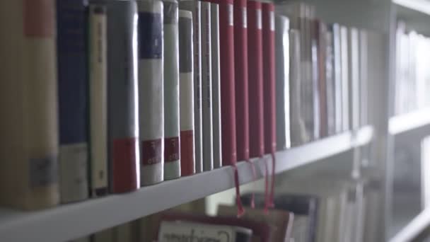 Dolly move of Library shelves with lots of books. — Stock Video