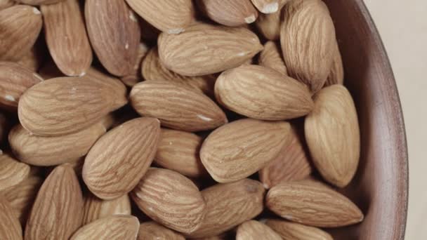 Almendras tostadas de primer plano en tazón de madera — Vídeo de stock