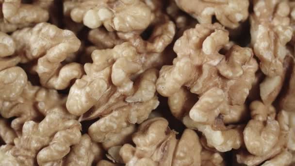 Dry walnut background, close up nut, rotation top view. Food background — Stock Video