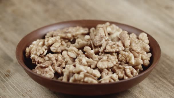 Woman Picks Up A Single walnut, To Eat, From Her Bowl. took a nut on the left side — Stock Video