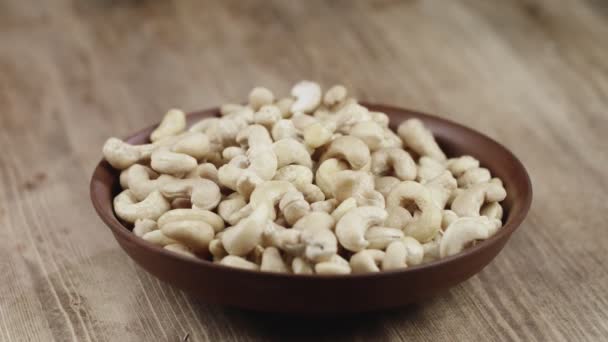 Woman Picks Up A Single Cashew, To Eat, From Her Bowl. took a nut on the right side — Stock Video