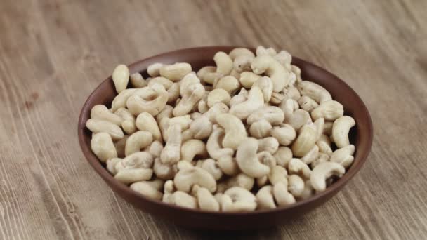 Woman Picks Up A Single Cashew, To Eat, From Her Bowl. took a nut on the right side — Stock Video