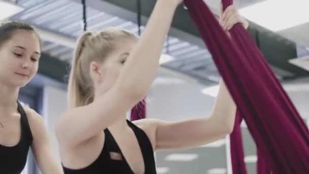 No ginásio mulher estende as pernas na rede acima do chão . — Vídeo de Stock