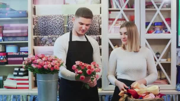 Молодая пара работает в цветочном магазине. — стоковое видео