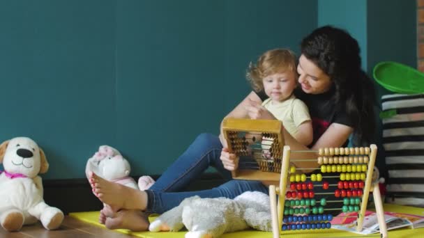 Moeder en dochter spelen met houten abacus — Stockvideo